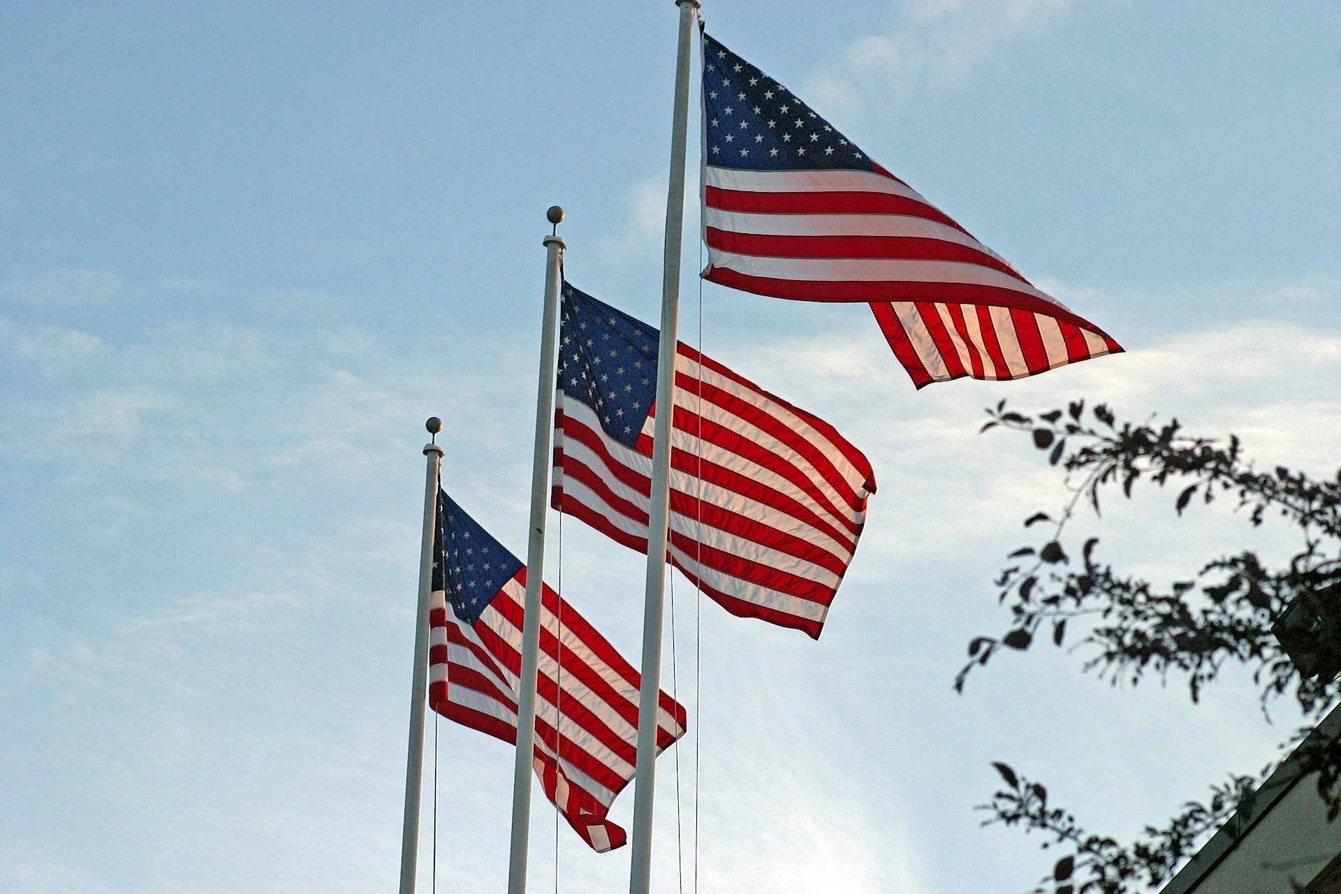 American flag flying on tall flagpole before a retirement ceremony